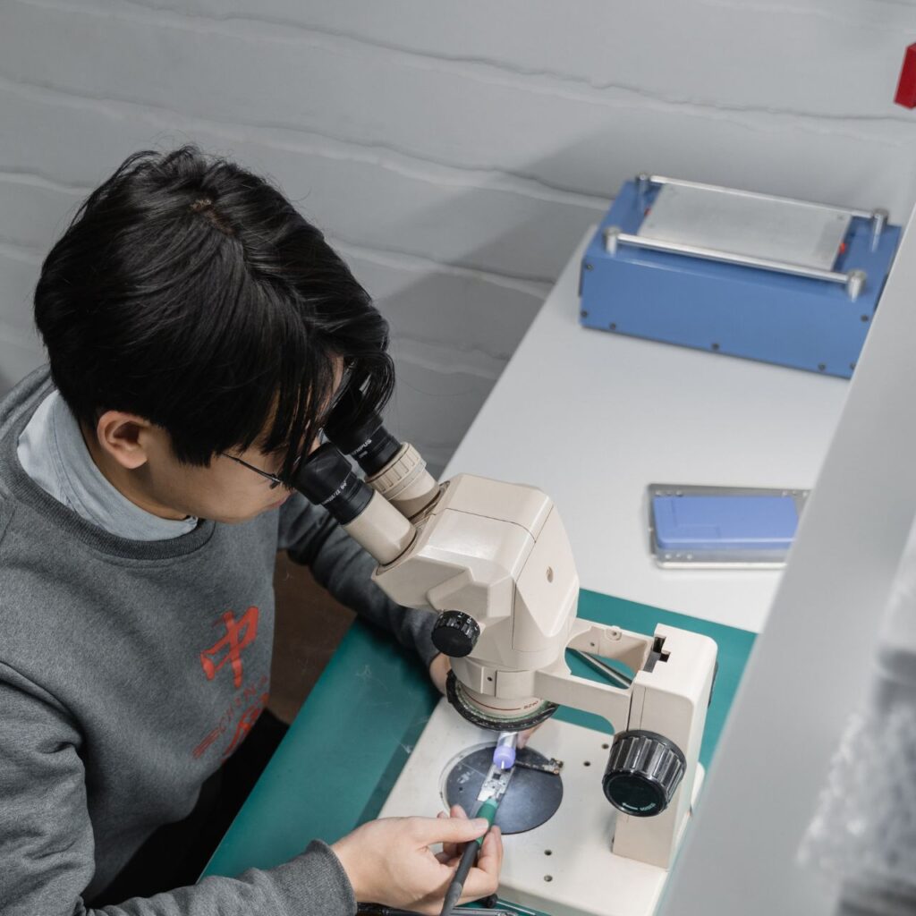 Professional hospital equipment repair technician servicing ICU monitoring system, Expert hospital equipment repair specialist working on surgical equipment